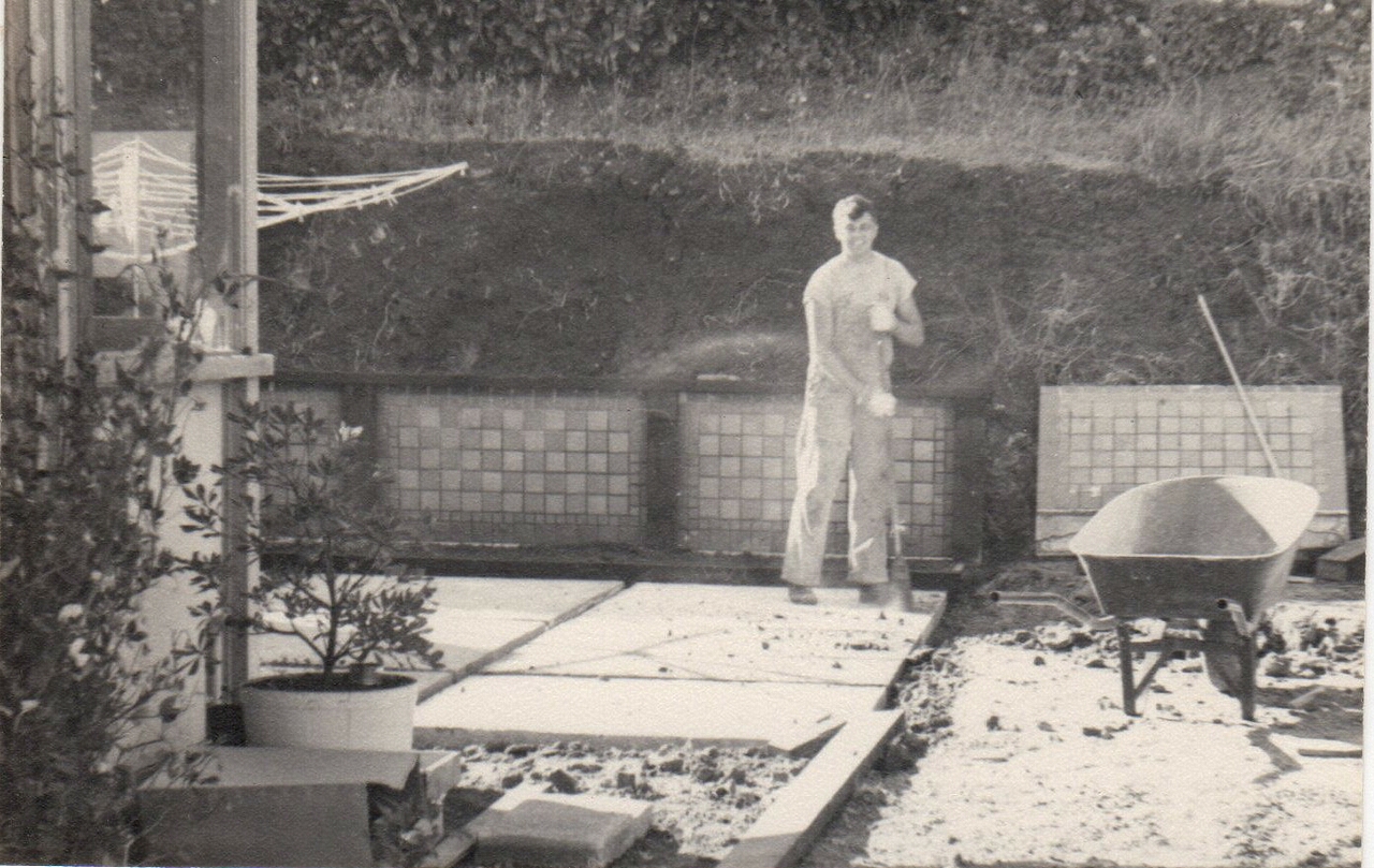 Dad is at work on the retaining wall and the patio where our clothes line was locaed.  Much of this area was covered over by my bedroom when it was added in 1955.