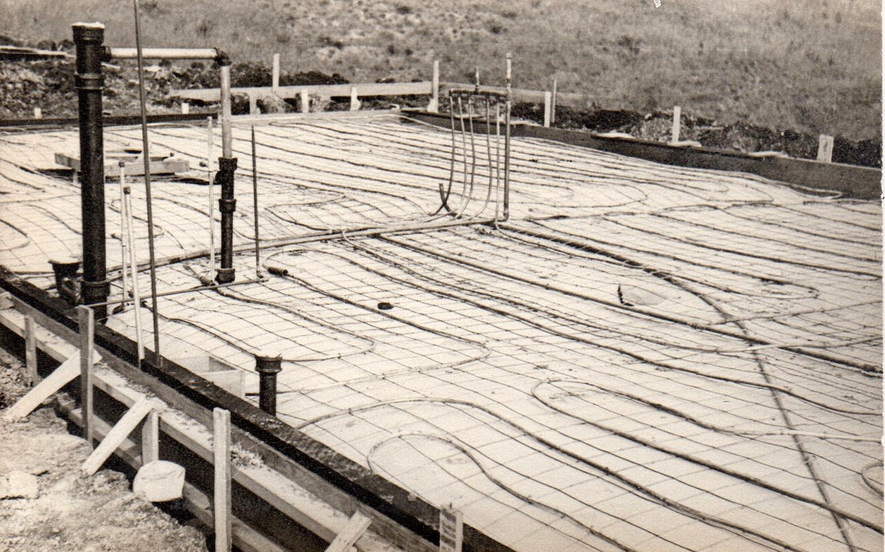 Showing the in-the-foundation copper pipes that provide five circuits of radiant heating - still works perfectly, 65 years later.